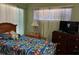 Cozy bedroom with natural light from the window, and a warm, inviting atmosphere at 8 E Summit St, Apopka, FL 32712