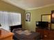 Bedroom features neutral walls, tile flooring, and a twin bed at 8 E Summit St, Apopka, FL 32712
