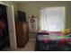 Comfortable bedroom with TV and spacious closet, offering convenience and style at 8 E Summit St, Apopka, FL 32712
