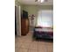 Cozy bedroom with tile flooring, a twin bed, and a closet for storage at 8 E Summit St, Apopka, FL 32712