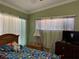 Inviting bedroom featuring a window with sheer curtains and neutral-toned walls at 8 E Summit St, Apopka, FL 32712