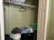 Open walk-in closet with wire rack shelves and bags on the floor at 8 E Summit St, Apopka, FL 32712