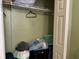 Open walk-in closet with wire rack shelves and bags on the floor at 8 E Summit St, Apopka, FL 32712