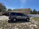 Home exterior showcasing a spacious front yard with a gray car parked on the lawn at 8 E Summit St, Apopka, FL 32712