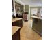A large kitchen with tan tile floors, an island and lots of decorations at 8 E Summit St, Apopka, FL 32712