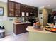 A kitchen with dark wood cabinets, a microwave and lots of decorations at 8 E Summit St, Apopka, FL 32712