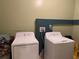 Functional laundry room featuring white washer and dryer units at 8 E Summit St, Apopka, FL 32712