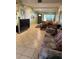 A living room with tile floors and multiple sofas at 8 E Summit St, Apopka, FL 32712