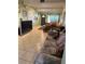 Interior living room displays tile flooring, cozy furniture, and a green door leading to the outside at 8 E Summit St, Apopka, FL 32712