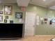Interior view of an office showing a door, bulletin boards, fire extinguisher and a television set at 8 E Summit St, Apopka, FL 32712