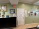 Interior view of an office showing a door, bulletin boards, fire extinguisher and a television set at 8 E Summit St, Apopka, FL 32712