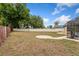 Back yard featuring privacy fence with mature trees and view of the rear of the home at 8453 Firefox Cv, Orlando, FL 32835