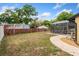 View of back yard with screen enclosed pool area and fence at 8453 Firefox Cv, Orlando, FL 32835
