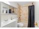 Cozy bathroom featuring a tiled tub and shower, a white vanity, and a neutral color scheme for a relaxing atmosphere at 8453 Firefox Cv, Orlando, FL 32835