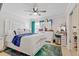 Bright bedroom with a white bed, mirrored furniture, and colorful decor creating a comfortable and stylish retreat at 8453 Firefox Cv, Orlando, FL 32835
