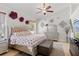 Comfortable bedroom featuring a well-lit space, stylish furniture, and calm decor with roses and soft bedding at 8453 Firefox Cv, Orlando, FL 32835