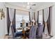 A stylish dining area with a glass-top table, seating for six, and elegant decor with lots of natural light at 8453 Firefox Cv, Orlando, FL 32835