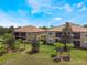 Aerial view of well-maintained buildings with lush green lawns and landscaping at 8925 Azalea Sands Ln # 602, Davenport, FL 33896