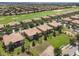 Aerial view of buildings with terra cotta roofs and well-maintained lawns, trees, and landscaping at 8925 Azalea Sands Ln # 602, Davenport, FL 33896