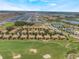 Picturesque aerial shot of a golf course community featuring beautiful landscaping and a serene lake at 8925 Azalea Sands Ln # 602, Davenport, FL 33896