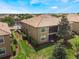 Aerial view showing well-maintained buildings with manicured lawns, trees, and landscaping at 8925 Azalea Sands Ln # 602, Davenport, FL 33896