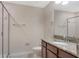 Well-lit bathroom featuring granite countertop, vanity, shower with glass doors and tile flooring at 8925 Azalea Sands Ln # 602, Davenport, FL 33896
