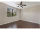 Cozy bedroom with hardwood floors, a ceiling fan and a window with natural light at 8925 Azalea Sands Ln # 602, Davenport, FL 33896
