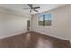 Bright bedroom with hardwood floors, ceiling fan, large window, and a glass door with a balcony at 8925 Azalea Sands Ln # 602, Davenport, FL 33896