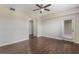 Neutral bedroom with hardwood floors and ceiling fan, plus a door to a balcony at 8925 Azalea Sands Ln # 602, Davenport, FL 33896