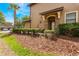 Inviting home entrance with lush landscaping, a stone facade, and a covered porch at 8925 Azalea Sands Ln # 602, Davenport, FL 33896