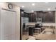 Well-equipped kitchen with stainless steel appliances and dark wood cabinets with granite countertops at 8925 Azalea Sands Ln # 602, Davenport, FL 33896