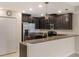 Contemporary kitchen with stainless steel appliances, granite countertops, and ample cabinet space at 8925 Azalea Sands Ln # 602, Davenport, FL 33896