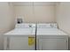 Laundry room featuring a washer and dryer with overhead shelving at 8925 Azalea Sands Ln # 602, Davenport, FL 33896