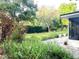 Beautiful backyard garden with a pathway and lush greenery surrounding the home at 29540 Deerwood Farms Rd, Sorrento, FL 32776