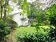 Home exterior with green lawn, mature trees, white brick and dark roof at 29540 Deerwood Farms Rd, Sorrento, FL 32776