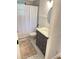 Cozy bathroom featuring a shower with a patterned curtain, toilet, and vanity at 29540 Deerwood Farms Rd, Sorrento, FL 32776