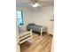 Bright bedroom with twin beds, ceiling fan, wood floors and natural light at 29540 Deerwood Farms Rd, Sorrento, FL 32776