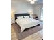 Bright bedroom featuring a luxurious king bed, two nightstands, and elegant lamps at 29540 Deerwood Farms Rd, Sorrento, FL 32776