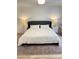 Bright bedroom featuring a luxurious king bed, two nightstands, and elegant lamps at 29540 Deerwood Farms Rd, Sorrento, FL 32776