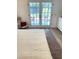 Bedroom with a comfy chair and access to a sunny outdoor patio through glass doors at 29540 Deerwood Farms Rd, Sorrento, FL 32776