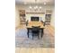 Charming dining room with a fireplace, bookshelves, and a rustic wooden table at 29540 Deerwood Farms Rd, Sorrento, FL 32776