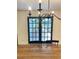 A view of black framed double doors with dining room table in the foreground at 29540 Deerwood Farms Rd, Sorrento, FL 32776