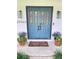 Charming blue front doors with glass panes and decorative plants enhancing curb appeal at 29540 Deerwood Farms Rd, Sorrento, FL 32776