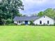 Charming one-story home with a well-manicured lawn and colorful landscaping at 29540 Deerwood Farms Rd, Sorrento, FL 32776