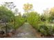 Lush garden path lined with young fruit trees and foliage at 29540 Deerwood Farms Rd, Sorrento, FL 32776