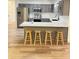 Charming kitchen with gray cabinets, modern appliances, and a cozy breakfast bar at 29540 Deerwood Farms Rd, Sorrento, FL 32776