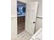 Laundry room with unique tiled floor leading into a kitchen with seating at 29540 Deerwood Farms Rd, Sorrento, FL 32776