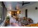 Inviting porch with dining table, chairs, and wicker furniture, ideal for relaxing at 29540 Deerwood Farms Rd, Sorrento, FL 32776