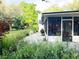 Backyard view towards the screened-in porch, featuring an outdoor seating area at 29540 Deerwood Farms Rd, Sorrento, FL 32776