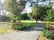 Scenic property view showcasing a long driveway leading to a white house at 29540 Deerwood Farms Rd, Sorrento, FL 32776
